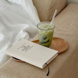 a book and drink on a couch