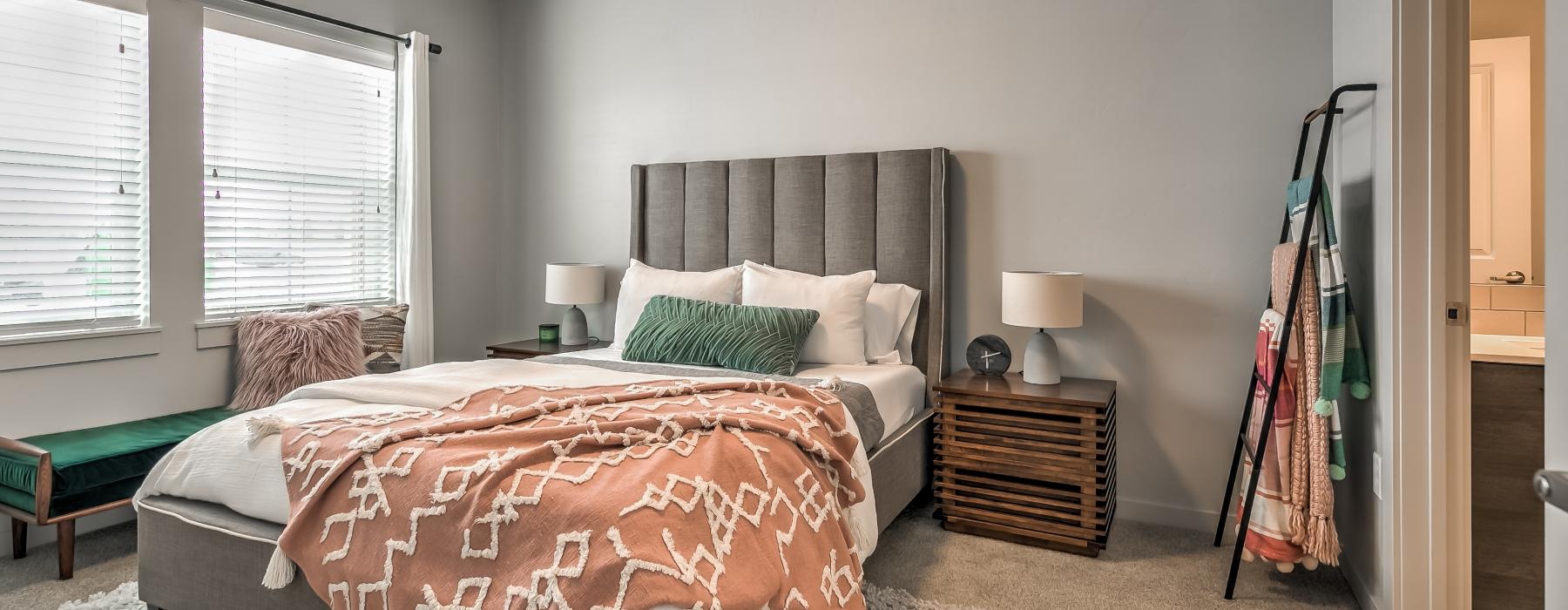 a bedroom with a bed and a lamp